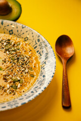 Pumpkin cream soup on a yellow background  
