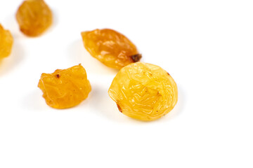 Dried yellow raisins on white background. Close up photo.
