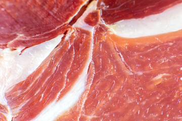 Red meat texture close up photo. Italian prosciutto crudo or jamon. Raw ham. Pork meat background.