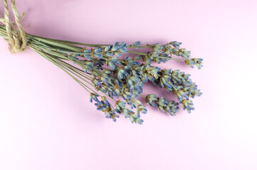 Decorative dry lavender bouquet on pink background. Close up.