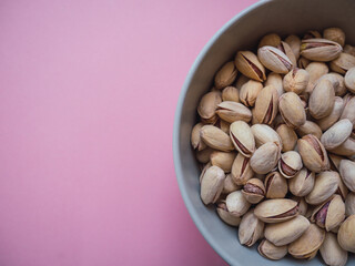 Top view pistachios with pink background. Copy space