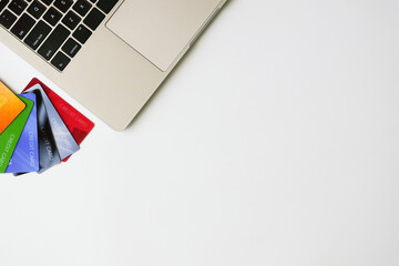 Fototapeta premium Top view laptop and credit cards with copy space. Shopping online concept. Flat lay.