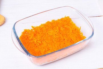 Step by step preparation of russian traditional new year appetizer  - herring under layers of boiled vegetables and mayonnaise (shuba). step 6  of 11  - put a layer of grated carrots in a bowl