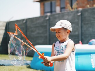 child playing with soap bubble net
