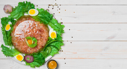 Homemade jelly on a white wooden table. Top view with copy space. Jelly with meat or beef aspic, a...