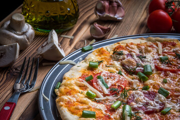 Delicious Italian pizza on wooden background. Soft focus.