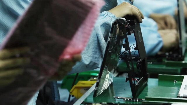 Laptop Factory, Technicians mounting Laptop Computers in the Production Line. 4K.