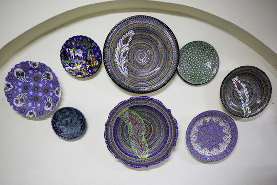 Blue painted ceramic plates hanging from wall
