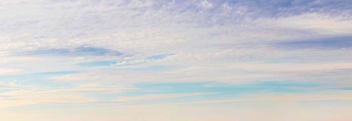 Panorama of the sky with unusual clouds at sunset