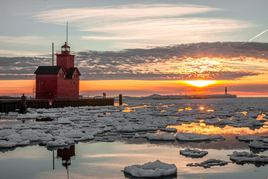 After a cold winter, Lake Michigan usually thaws in the early spring.  The melting ice and snow make sunsets even more beautiful.
