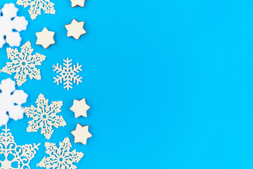 Flat layout of decorative snowflakes and firtrees with copyspace on the right