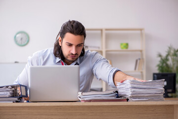 Young male employee unhappy with excessive work