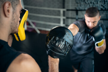 two muscle boxers sport man training and fighting on boxing ring at gym