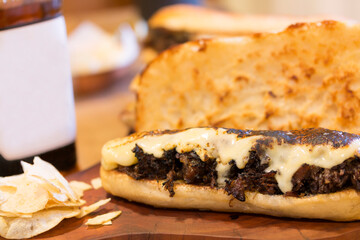 Meat and potato snack. Meat snack with melted cheese. Snack of shredded meat with cheese.