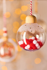 Transparent toy ball with decorations inside hanging in front of camera