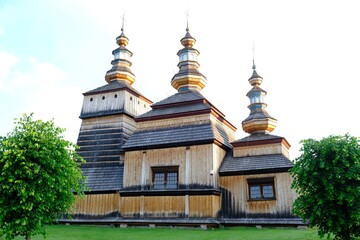 Beautiful historic wooden Orthodox church in the village of Krempna on a sunny morning. Low Beskids Mountains, Poland