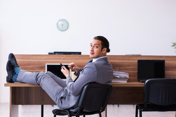 Young male employee working in the office