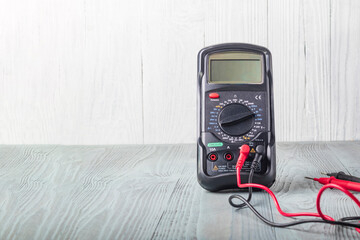 Studio lighting. wooden background in retro style with stained glass painting. Voltmeter. Close-up