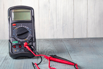 Studio lighting. wooden background in retro style with stained glass painting. Voltmeter. Close-up