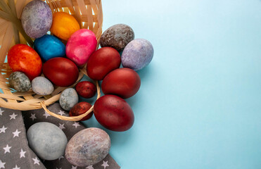 Colorful eggs spilled out of the basket. The Concept Of Easter