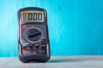 Studio lighting. wooden background in retro style with stained glass painting. Voltmeter. Close-up