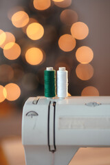 A close-up of different threads - white and green. Sewing concept. Bokeh effect