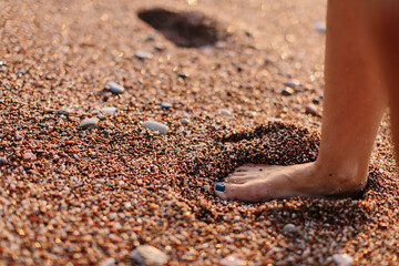 woman's foot in the sand on the beach