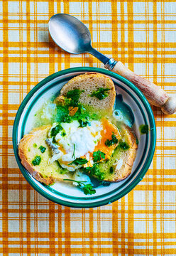 Acorda Alentejana, typical Portuguese soup, over a vintage tablecloth.