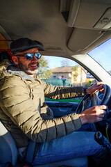 man driving a car with sunglasses