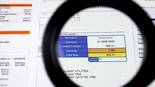 Communal payments. Close-up service invoice. Shooting through a magnifying glass