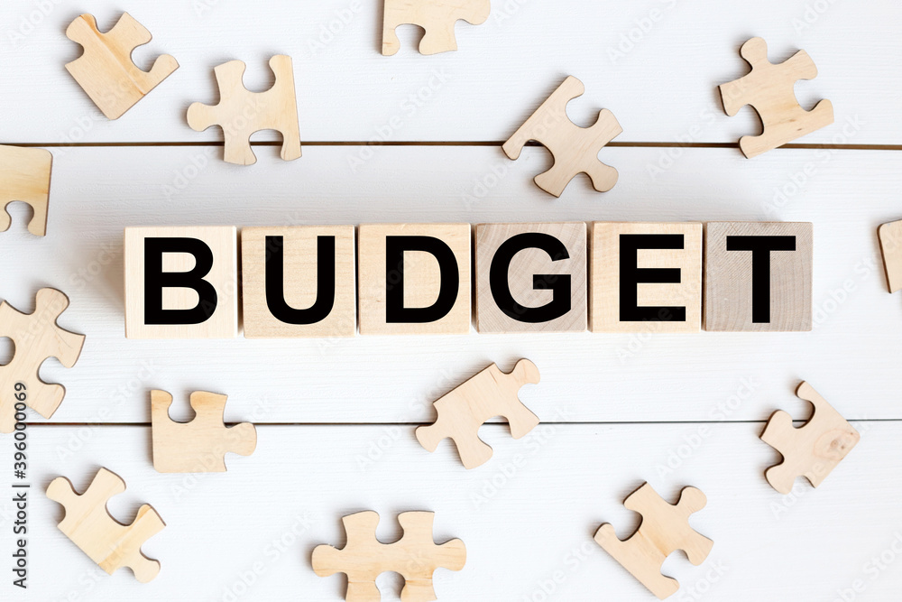 Poster budget word from building blocks. wooden blocks with the text: budget. the text is written in black 