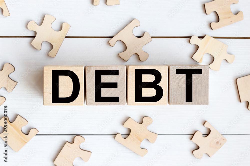 Poster debt word made from building blocks. wooden blocks with the text: budget. the text is written in bla