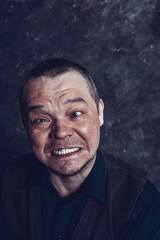 Middle aged social marginal emotional studio portrait.