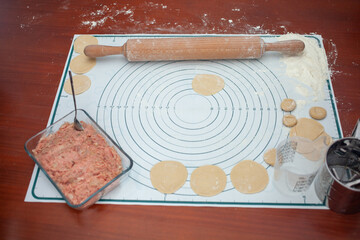 Cooking homemade dumplings. Ravioli with minced meat.