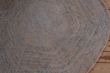 dark vintage round rug on wooden floor top view close up