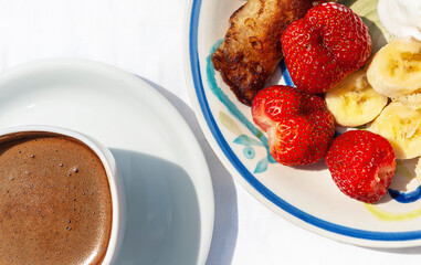 healthy breakfast or morning coffee on the table in white plates close-up top view