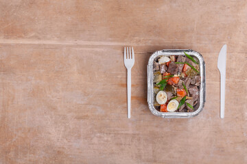 healthy food delivery and roasted meat with egg and carrot in takeaway lunch box