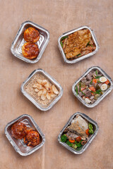 take away lunch boxes with fresh meal in foil container or healthy food delivery