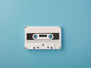White audio cassette on blue background