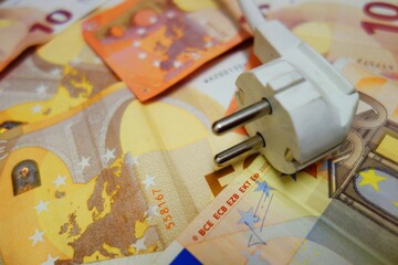 power costs - power plug on banknotes