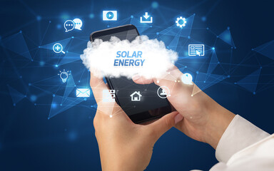 Female hand holding smartphone with SOLAR ENERGY inscription, cloud technology concept