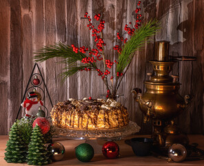 
Cake on a crystal stand, Christmas tree decorations, and flowers on the table.Very beautiful background.