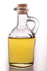 Oil in a glass container with a stopper. A jug of olive oil used in the household.