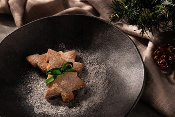 Christmas tree-shaped cookies on rustic plate