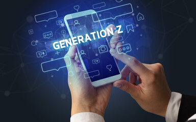 Female hand typing on smartphone with GENERATION Z inscription, social media concept