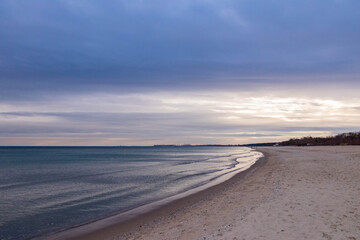 
beautiful calm sea waving in the early morning on a golden sandy beach