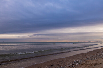 Fototapeta na wymiar beautiful calm sea waving in the early morning on a golden sandy beach