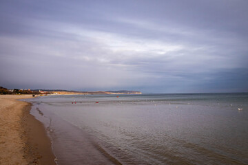 beautiful calm sea waving in the early morning on a golden sandy beach