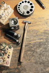 Top view of different goldsmiths tools on the jewelry workplace. Desktop for craft jewelry making...