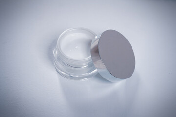 An open jar of cream on a light background.The view from the top.The concept of skin health